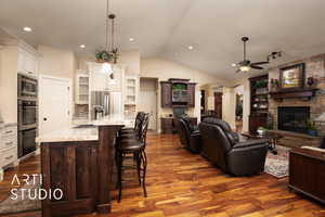 Kitchen featuring sink, pendant lighting, a kitchen breakfast bar, and a large island