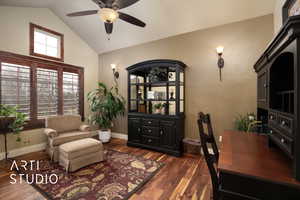 Home office with lofted ceiling, dark wood-type flooring, and ceiling fan