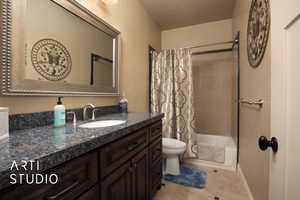 Guest Full bathroom featuring vanity, toilet, tile patterned floors, and shower / bath combo with shower curtain