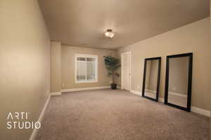 Carpeted empty room with a textured ceiling