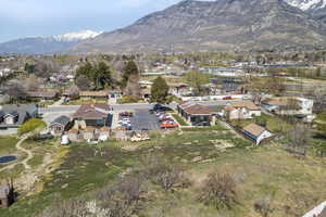 Aerial overview of property's location with nearby suburban area and mountains