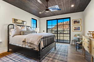 Bedroom featuring access to exterior, dark hardwood / wood-style floors, ceiling fan, and wood ceiling