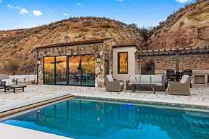 View of pool with a mountain view, an outdoor hangout area, and a patio area