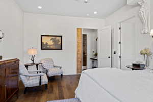 Bedroom with dark hardwood / wood-style floors