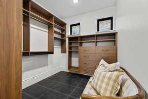 Walk in closet featuring dark tile patterned flooring