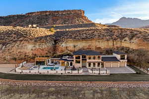 Rear view of property featuring a lawn and a mountain view