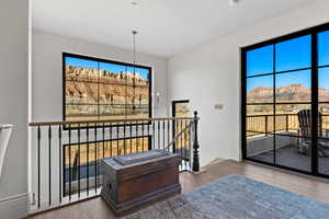 Interior space featuring a mountain view, hardwood / wood-style flooring, and a notable chandelier