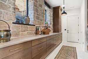 Kitchen featuring light tile patterned floors and pendant lighting