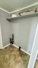 Laundry area featuring tile patterned floors