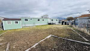 Back of house featuring a yard