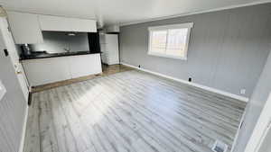 Interior space with sink and light wood-type flooring