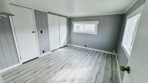 Unfurnished bedroom with light hardwood / wood-style floors