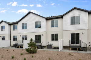 Rear view of property with central AC and a patio area