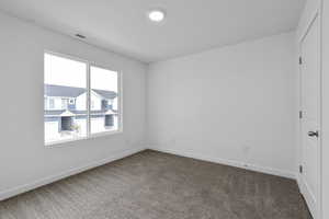 Empty room with dark colored carpet