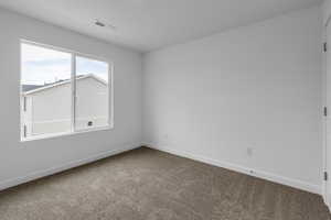 Empty room featuring carpet flooring