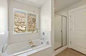 Bathroom featuring plus walk in shower and tile patterned floors