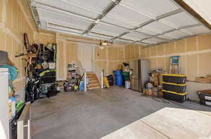 Garage with a garage door opener and stainless steel refrigerator with ice dispenser