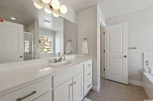 Bathroom featuring tile patterned floors, an enclosed shower, and vanity