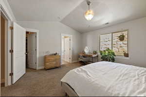 Bedroom featuring vaulted ceiling, ceiling fan, and light colored carpet