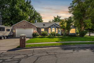 View of front of house featuring a garage and a yard