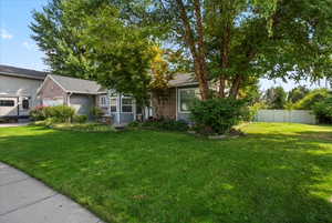 View of front of home featuring a front yard and a garage