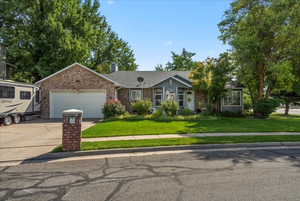 View of front of home featuring a garage and a front lawn