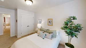 Carpeted bedroom featuring a closet