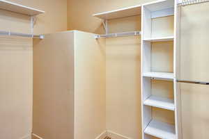 Bright spacious walk-in closet featuring with customized storage options