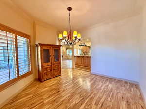 Dining area featuring light hardwood / wood-style floors and a chandelier