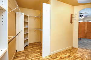 Bright spacious walk-in closet featuring with customized storage options