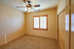 4th bedroom, carpeted with closet and wood shuttered window.