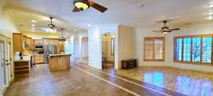 Kitchen with appliances with stainless steel finishes, a kitchen island, and ceiling fan