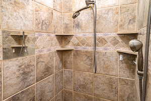 Primary bathroom shower room details featuring custom tile work.