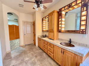 Bathroom with ceiling fan, tile patterned flooring, and vanity