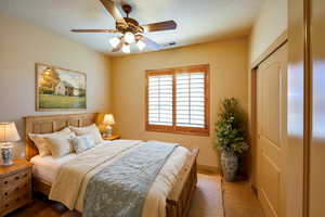 Virtually staged 4th bedroom, carpeted with closet and wood shuttered window.