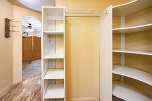 Bright spacious walk-in closet featuring with customized storage options