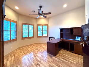 Office area with ceiling fan and light hardwood / wood-style flooring