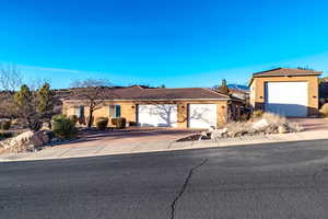 Ranch-style house featuring stucco exterior driveway, a tiled roof, and additional parking an attached 3 car garage and 42 x 22 RV garage