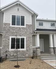 View of front of home featuring central air condition unit and a porch