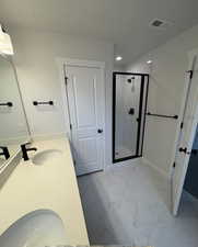 Bathroom with vanity, a textured ceiling, and walk in shower