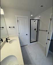 Bathroom featuring vanity, an enclosed shower, and a textured ceiling