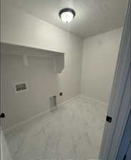 Laundry area featuring washer hookup, a textured ceiling, and electric dryer hookup