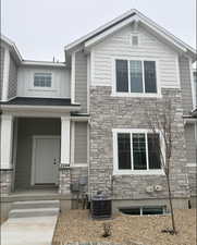 View of front of property with cooling unit