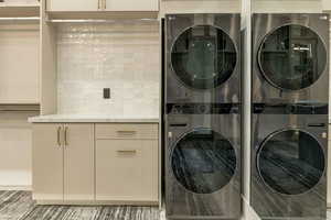 Laundry area with stacked washer and clothes dryer