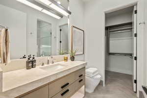 Bathroom featuring toilet, tile patterned flooring, an enclosed shower, and vanity