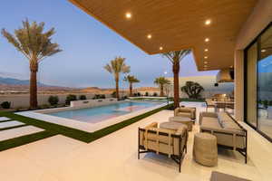 View of swimming pool featuring a patio area, an outdoor living space, and a mountain view