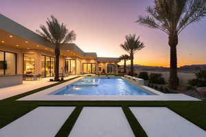 Pool at dusk with a patio