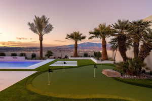 Surrounding community with a mountain view and a swimming pool