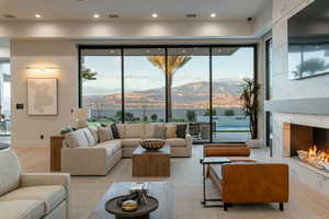 Living room with light wood-type flooring and a premium fireplace