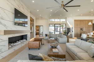 Living room featuring an inviting chandelier and a premium fireplace